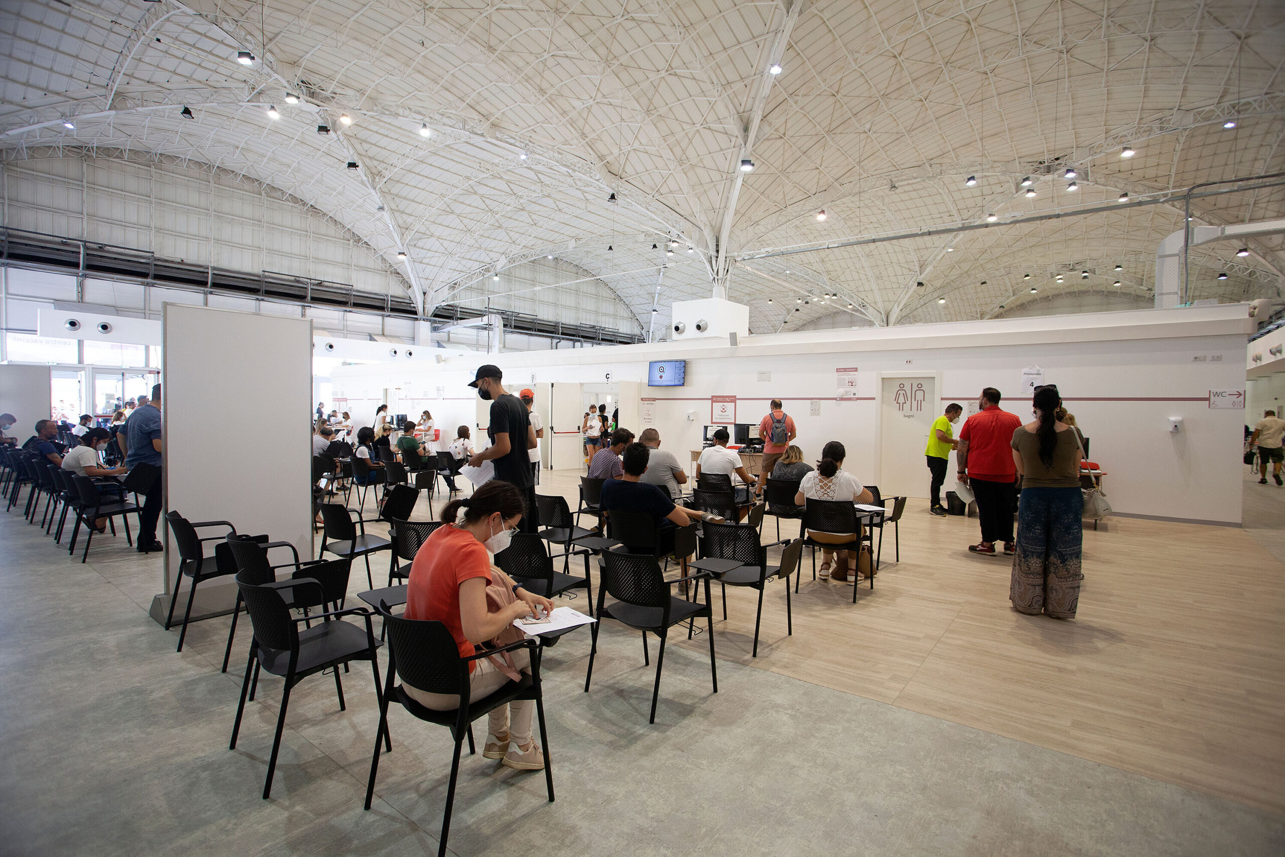 People wait in a vaccination center on August 7 in Bari